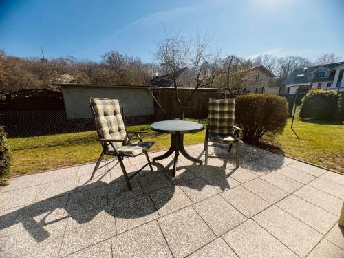 two chairs and a table on a patio at Ferienwohnung Shar Pei in Thiessow