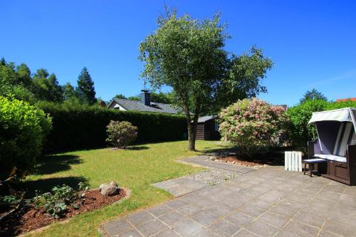 a garden with a tree and a gazebo at Neu Süllitz, Bungalow 50 in Neu Süllitz