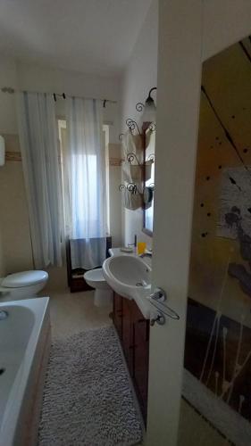 a bathroom with a sink and two toilets and a tub at Al Centro - Gaeta in Gaeta