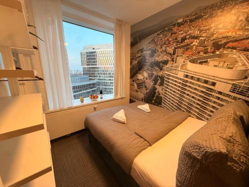 a bedroom with a view of a city at Zora Exclusive Apartments by CHORS in Bratislava