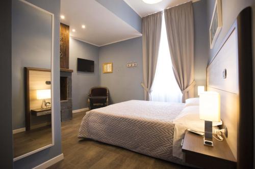 a hotel room with a bed and a mirror at Luxury B&B La Spelunca in Santa Maria Capua Vetere