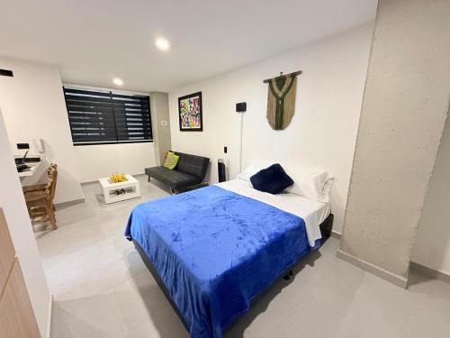 a bedroom with a bed and a couch and a desk at New studio, exceptional location with parking in Santa Rosa de Cabal