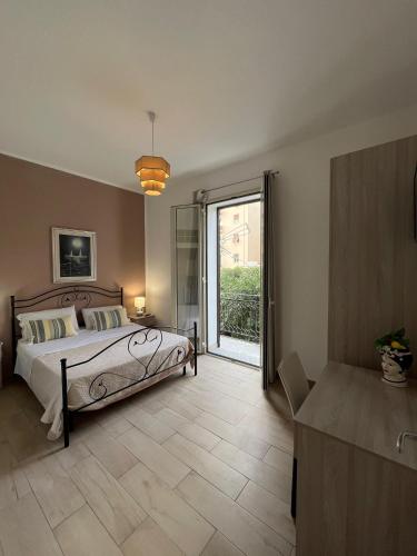 a bedroom with a bed and a sliding glass door at Antiche mura in Palermo