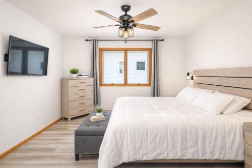 a bedroom with a bed and a ceiling fan at East Side 3 Br 2 full bath King Bed in Appleton