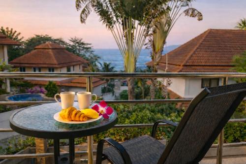 a table with a plate of food on a balcony at SAMUI BOHO Family Villa 4BR with Pool Renovated 2026 in Nathon Bay