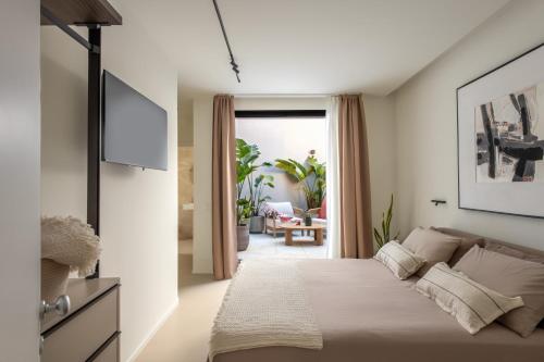 a bedroom with a bed and a living room at Casa Marella in Balestrate