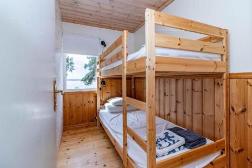 a bunk bed room with two bunk beds in a cabin at VMA945-Koeping-Avhulta-Gard-1 in Köping