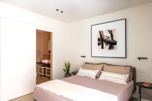 a bedroom with a bed with white walls at Casa Marella in Balestrate