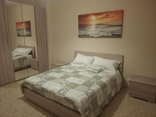 a bedroom with a bed and a mirror at Dimora Angelica in Statte