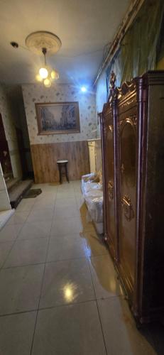 a room with a large wooden cabinet on a tile floor at Apartament w Centrum Ząbkowic Śląskich z Dwoma Sypialniami in Ząbkowice Śląskie