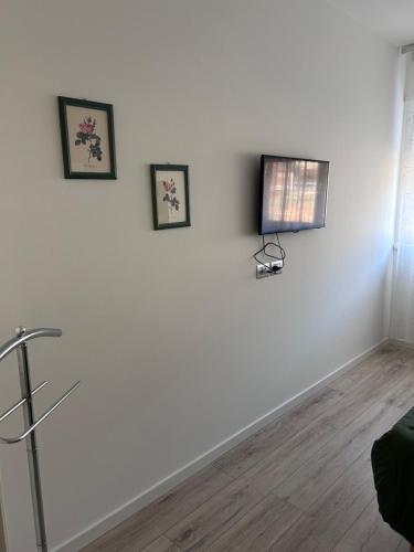 a white room with three pictures on the wall at Casa Edoardo in Cavedine