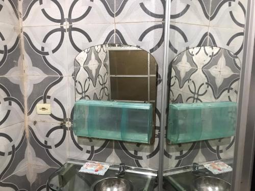 a mirror on a wall in a bathroom at casa boa vista in Recife