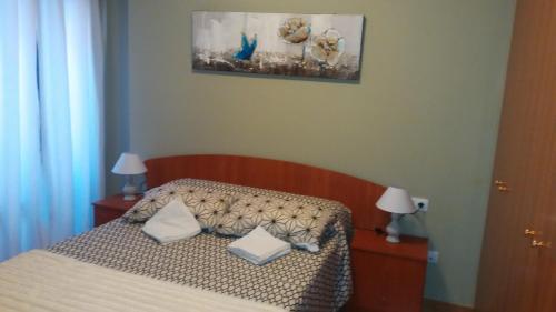 a bedroom with a bed with two pillows on it at Apartamento San Martín in Teruel