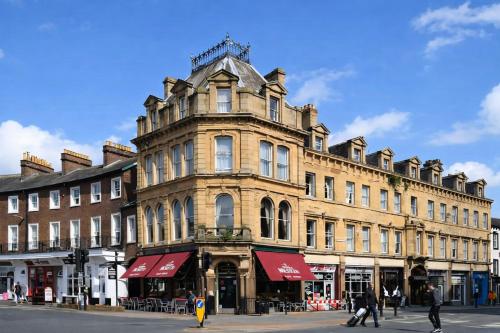 a large building on the corner of a street at The County Hotel in Carlisle