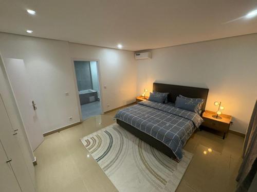 a large bedroom with a bed and a rug at Studio B Luxury - Waterfront in Dakar