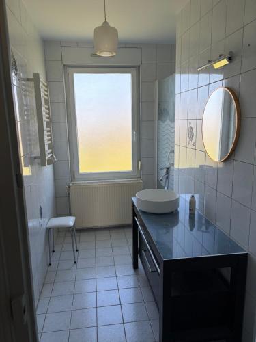 a bathroom with a sink and a mirror at La Parenthèse in Sagy