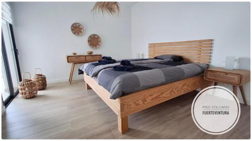 a bedroom with a large bed and a mirror at Piso Volcano in Villaverde