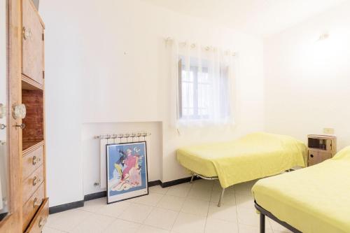 a bedroom with two beds and a painting on the floor at Levanto lodge in Levanto
