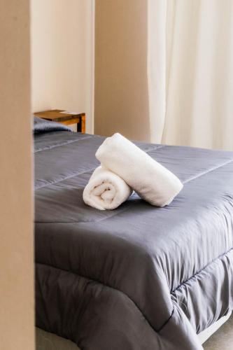 a towel is sitting on a bed at Hotel BIOCERRO in Tandil