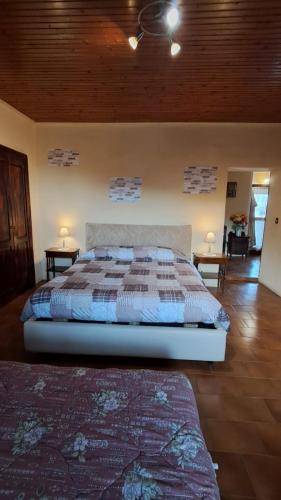 a bedroom with a bed with two night stands and two tables at La dimora del lago in Meina