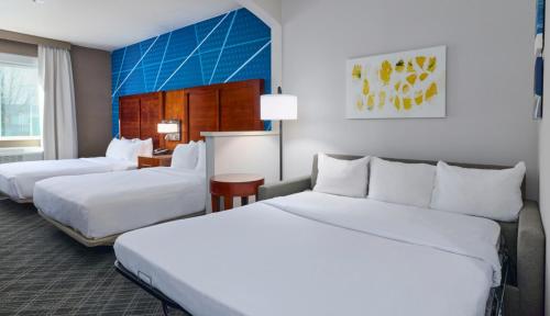 two beds in a hotel room with white sheets at Comfort Suites Springfield-Eugene in Springfield