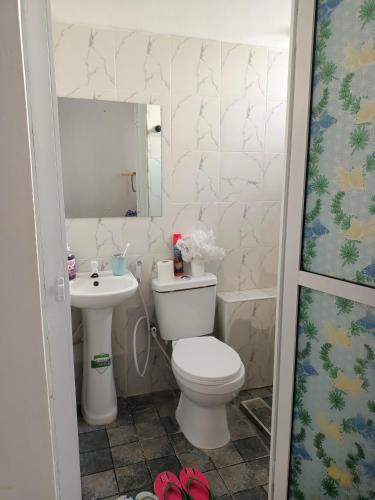 a bathroom with a toilet and a sink at Ardina Studio in Mtwapa