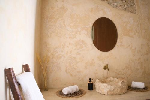 a bathroom with two towels and a mirror on the wall at Suite Privada Origen 63 Centro Histórico Mérida in Mérida