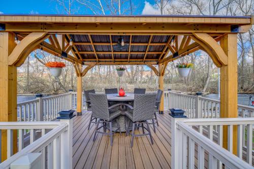a wooden deck with a table and chairs on it at Bristol Retreat with Creek Access 2 Mi to Dtwn in Bristol