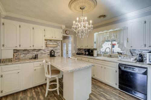 a kitchen with white cabinets and a chandelier at Bristol Retreat with Creek Access 2 Mi to Dtwn in Bristol
