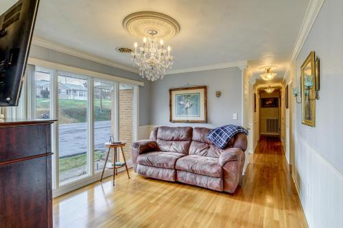 a living room with a couch and a chandelier at Bristol Retreat with Creek Access 2 Mi to Dtwn in Bristol