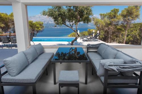 a living room with a couch and a table at Villa Azure Bay in Povlja