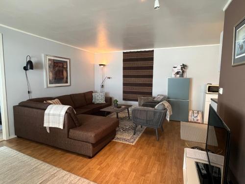 a living room with a couch and a table at Lykkebo in Tromsø