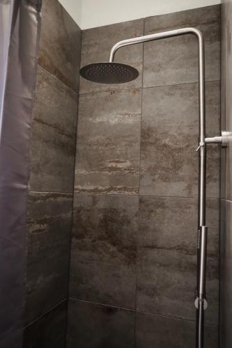 a shower with a glass door and a shower head at Billund Guest Lodge in Grindsted