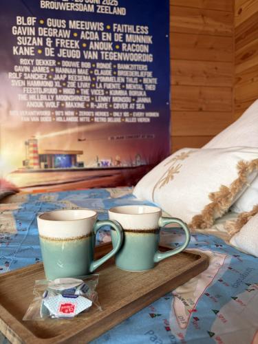 two coffee cups on a tray on a bed at B&B Bed in Burgh in Burgh Haamstede