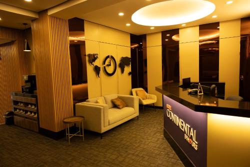 a lobby of a hotel with a couch and chairs at Hotel Continental ByHours in Bogotá