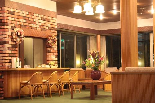 a lobby with a table and chairs and a bar at Kawaguchiko Hotel in Fujikawaguchiko