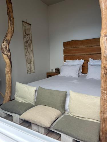a bedroom with a large bed with a wooden headboard at Janela para o Atlântico in Porto Moniz