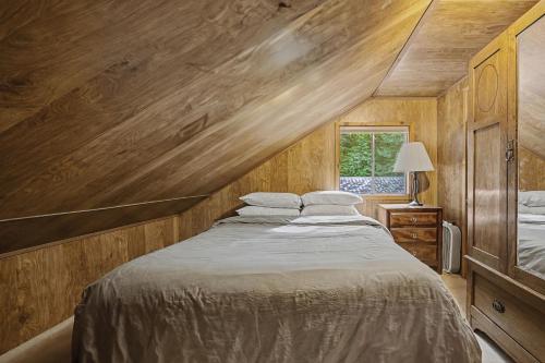 a bedroom with a large bed and a window at Crystal Creek Chalet - Meredith Lodging in Welches
