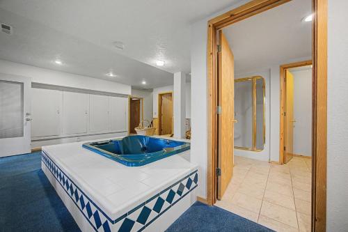 a large bathroom with a blue tub in a room at Crystal Creek Chalet - Meredith Lodging in Welches