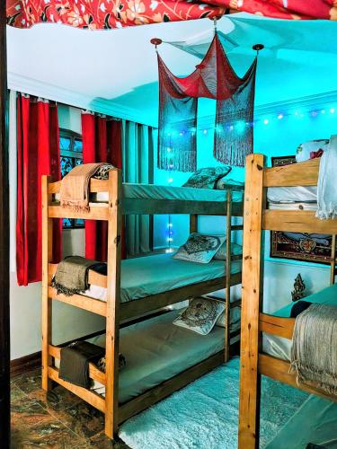 a room with three bunk beds in a room at Vila Urban Hostel ॐ Jardins in São Paulo