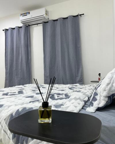 a black table sitting on top of a bed at Elite Apartment in Nizwa