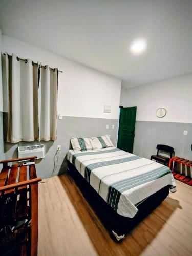 a bedroom with a bed in a room at Ap Umarizal l WiFi 500MB in Belém