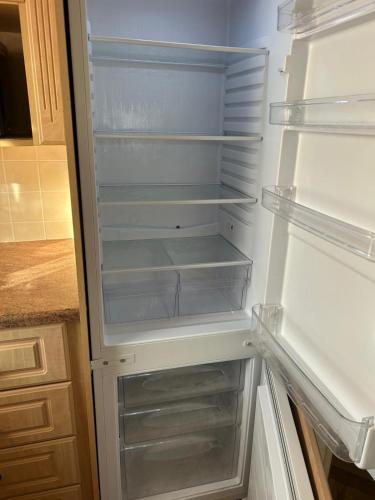 an empty refrigerator with its door open in a kitchen at 6 berth caravan ensuite the chase in Ingoldmells