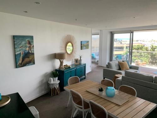 a living room with a couch and a table at The Bay Riveria in Napier