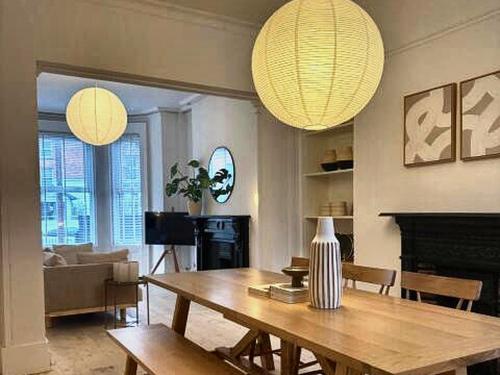 a living room with a wooden table and a couch at Spacious Victorian Group Retreat | Gated Parking in Belfast