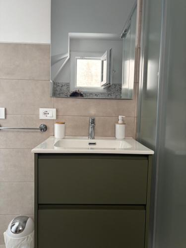 a bathroom with a sink and a mirror at Piazza Maggiore in Sulmona