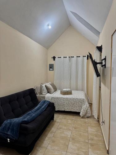 a living room with a couch and a bed at Finca Nona's, Naturaleza y playa in Ciudad Madero