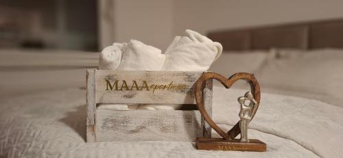a box of towels and a pair of scissors at MAAA Apartman in Tuzla
