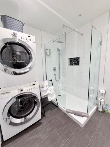 a washing machine in a bathroom with a shower at La Première vue in Magog-Orford
