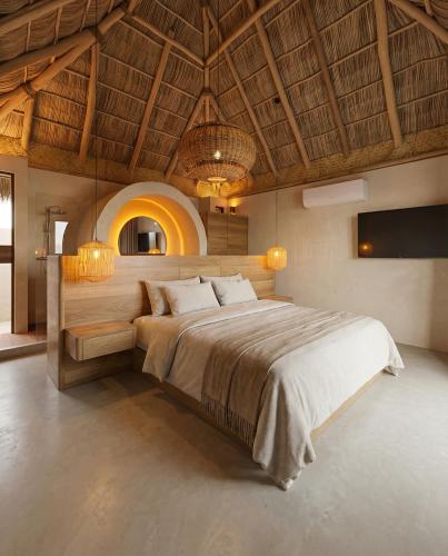 a bedroom with a large bed with a wooden ceiling at Mayto Astrological Park in Maito